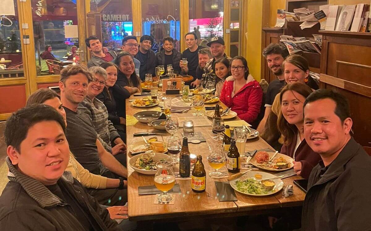 A big part of our group at dinner smiling to the camera.