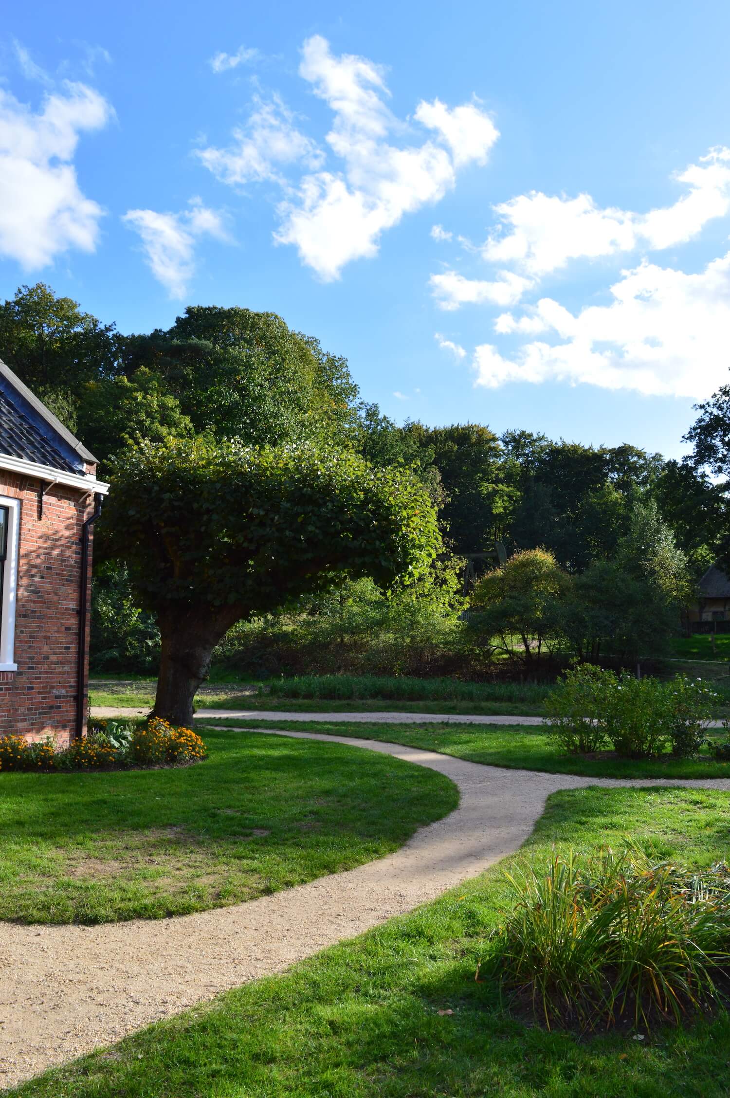 Landscape picture in the open air museum Arnhem, featuring a nice crossroad with a lots of grass and nice trees